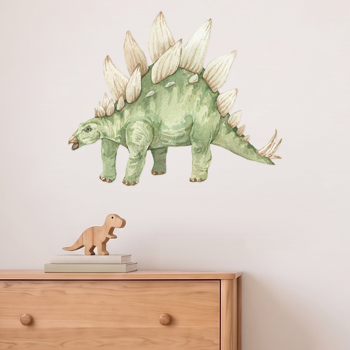 Large stegosaurus wall decal above an oak chest of drawers in a kids' bedroom