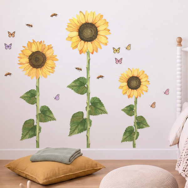 Three tall hand-painted sunflower wall decals with butterflies and honey bees in a girls' bedroom