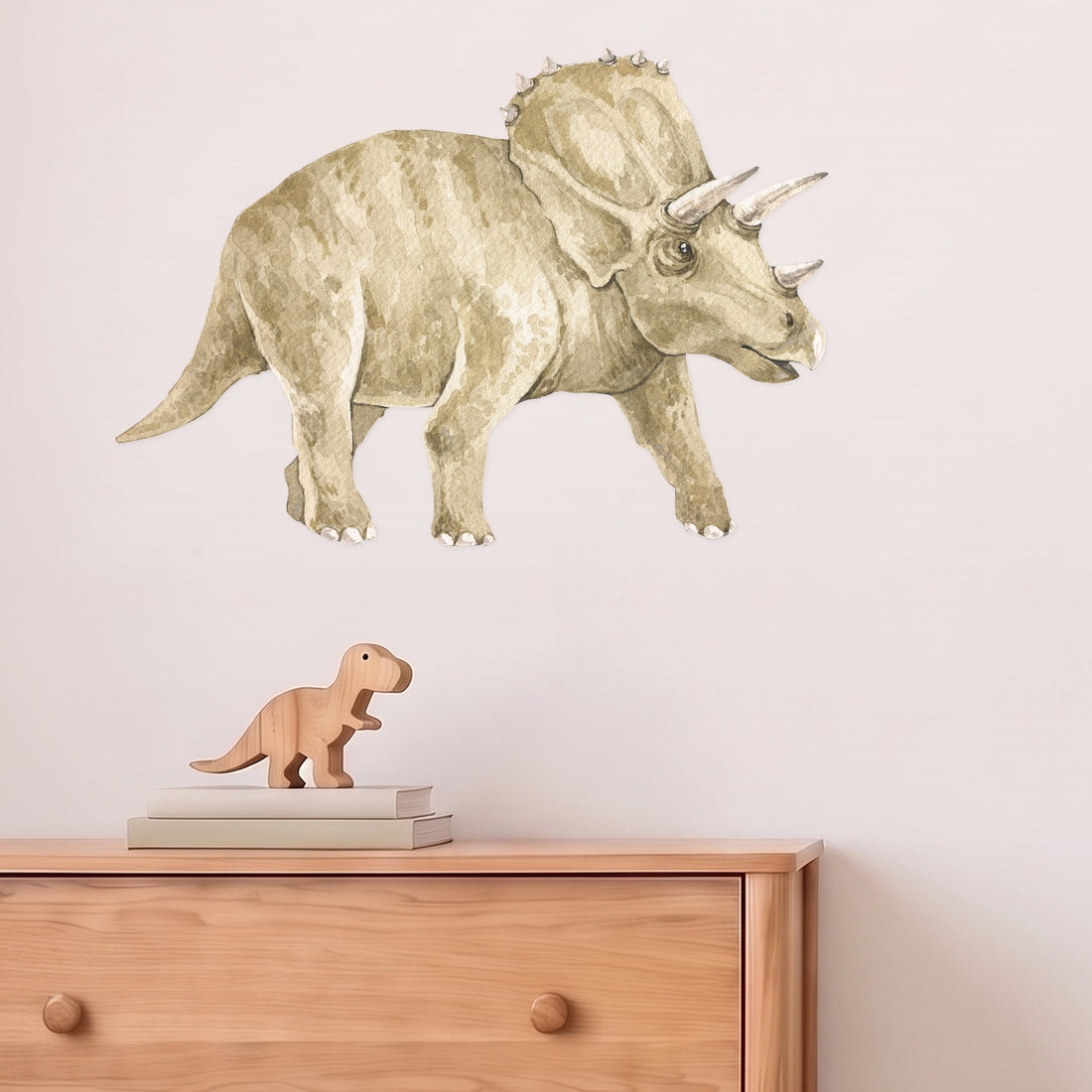 Large triceratops wall decal above an oak chest of drawers in a kids' bedroom