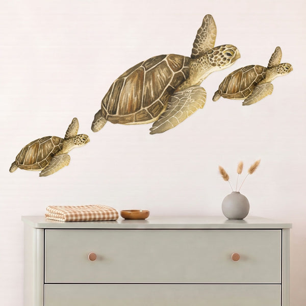 Large sea turtle family wall decals, a turtle and two babies swimming above a sage dresser in a nursery