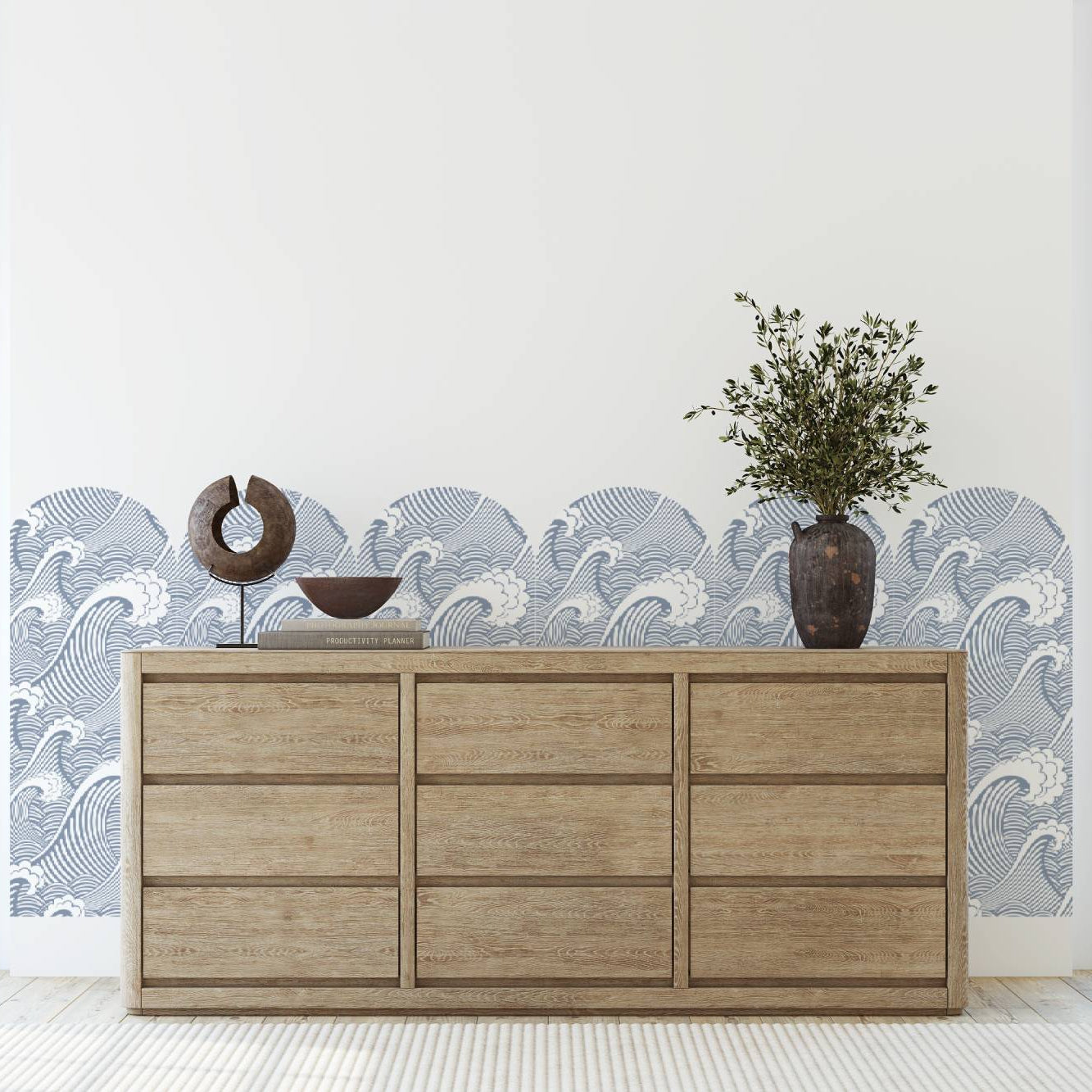 Wooden dresser with decorative items against a wall with wave pattern