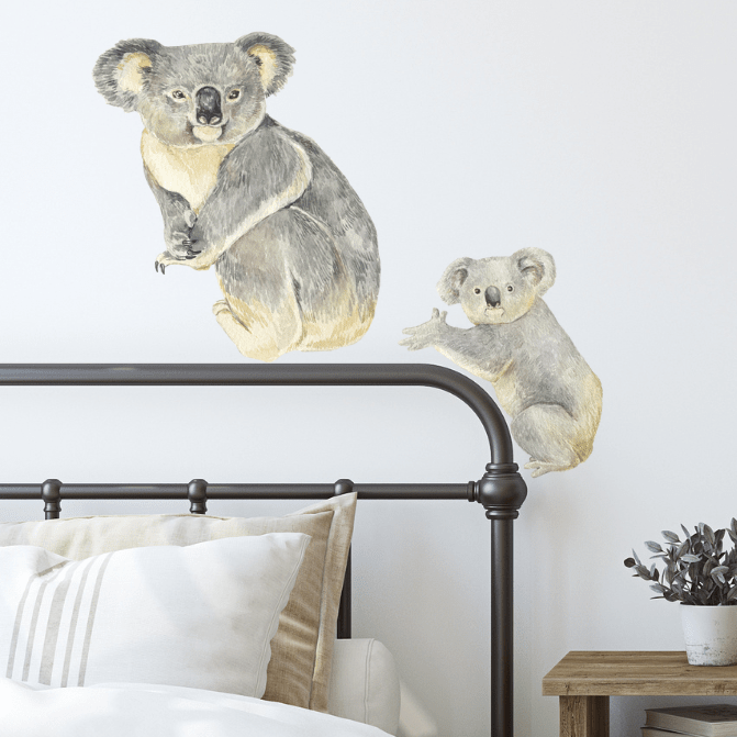 Mother and baby koala wall decals above an iron bed