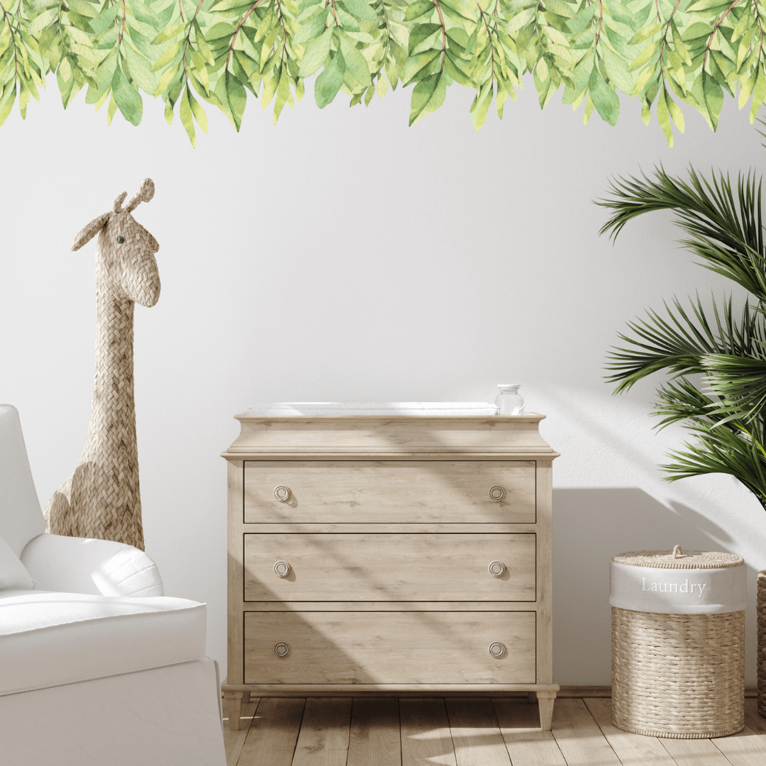 Green leaf wall trim decal along the top of a wall above a timber dresser