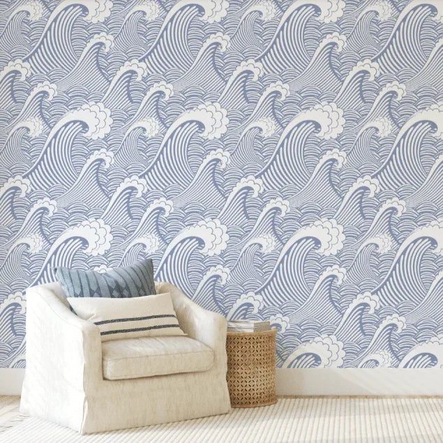 Blue Japanese Wave wallpaper behind a cream armchair and woven basket