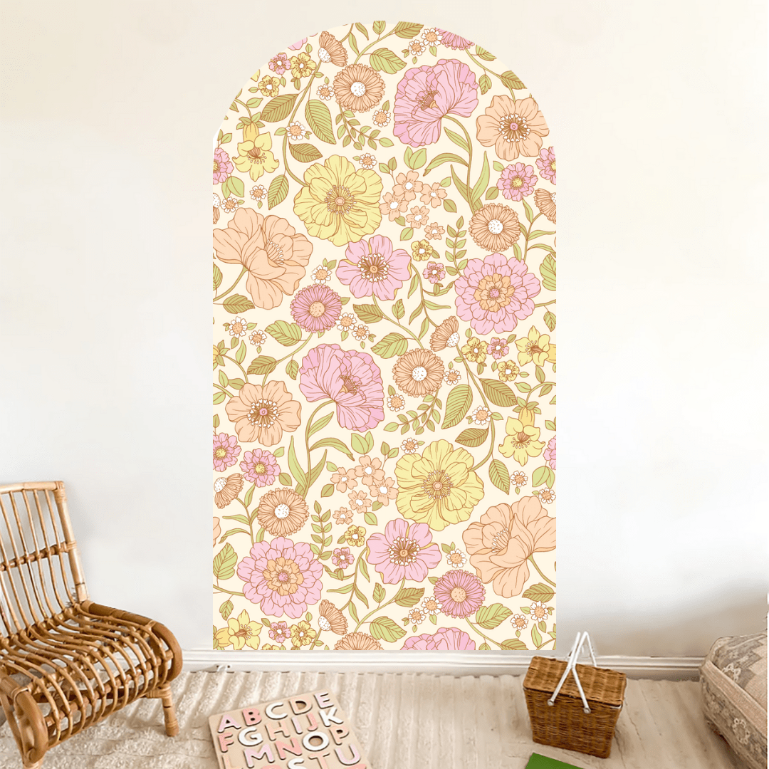 Juliet floral arch decal in pink and yellow beside a cane chair