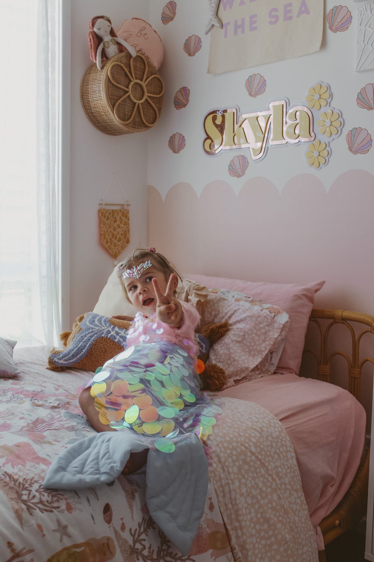 Customer photo of a child with sea shell decals and a name sign