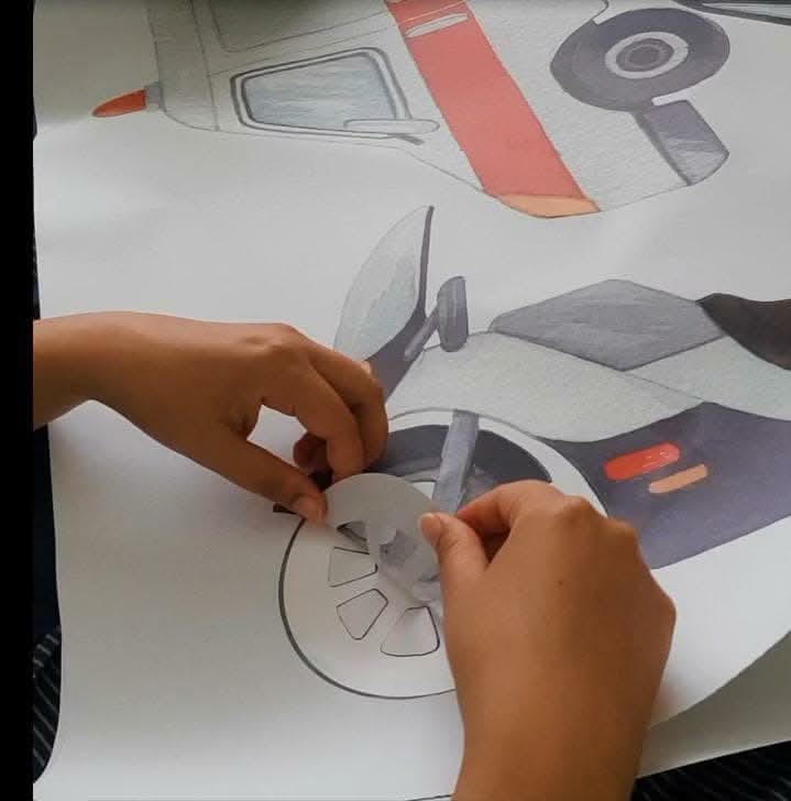 Hands peeling an emergency vehicle decal from its backing sheet