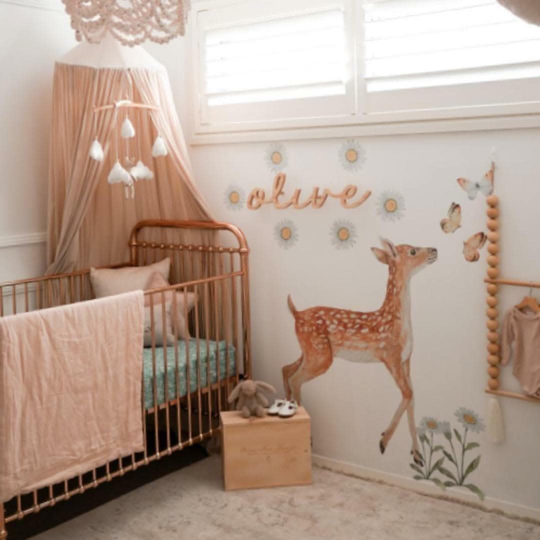 Deer wall decal in a nursery styled with a canopy and hanging foliage decals