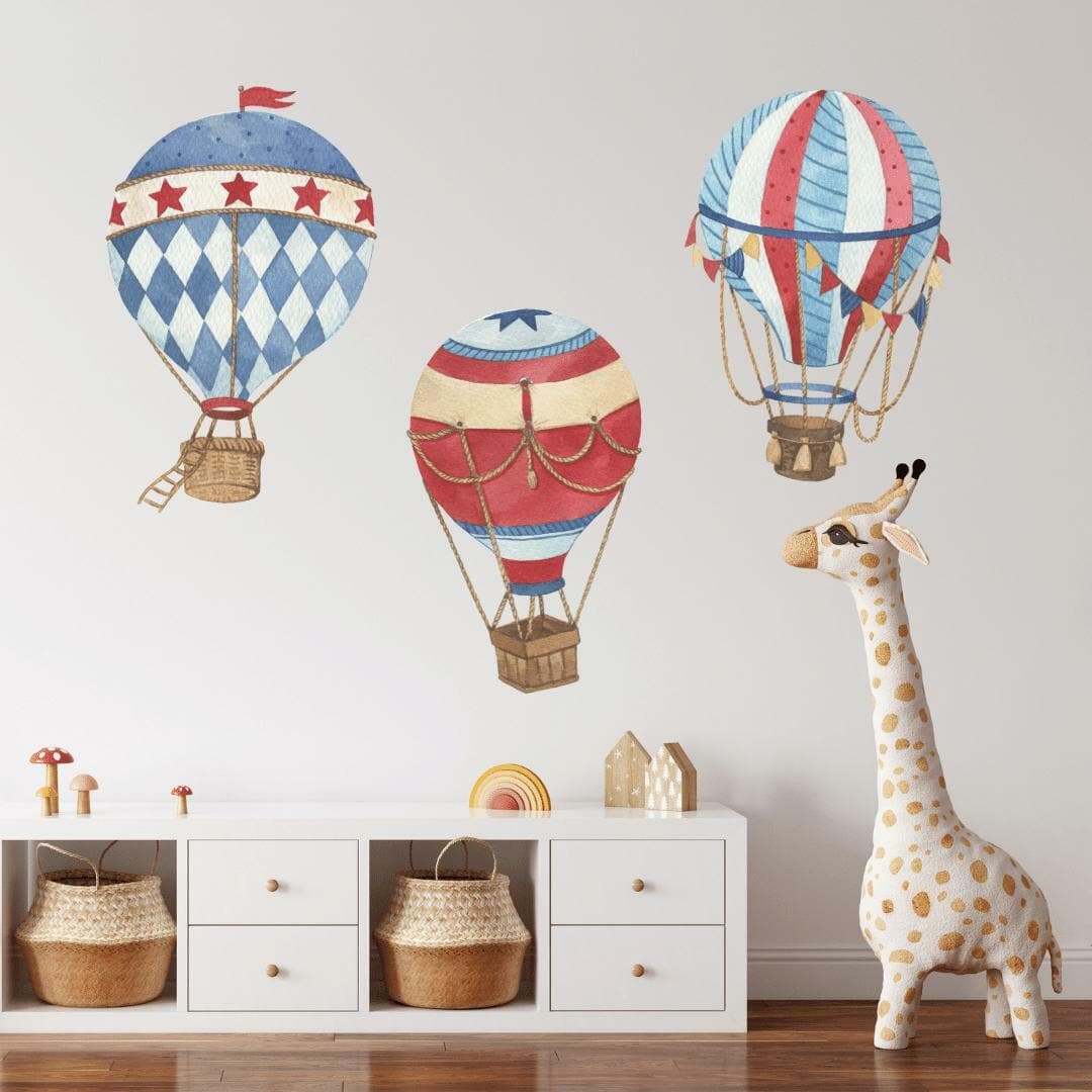 Hot air balloon wall decals in red and blue above storage baskets