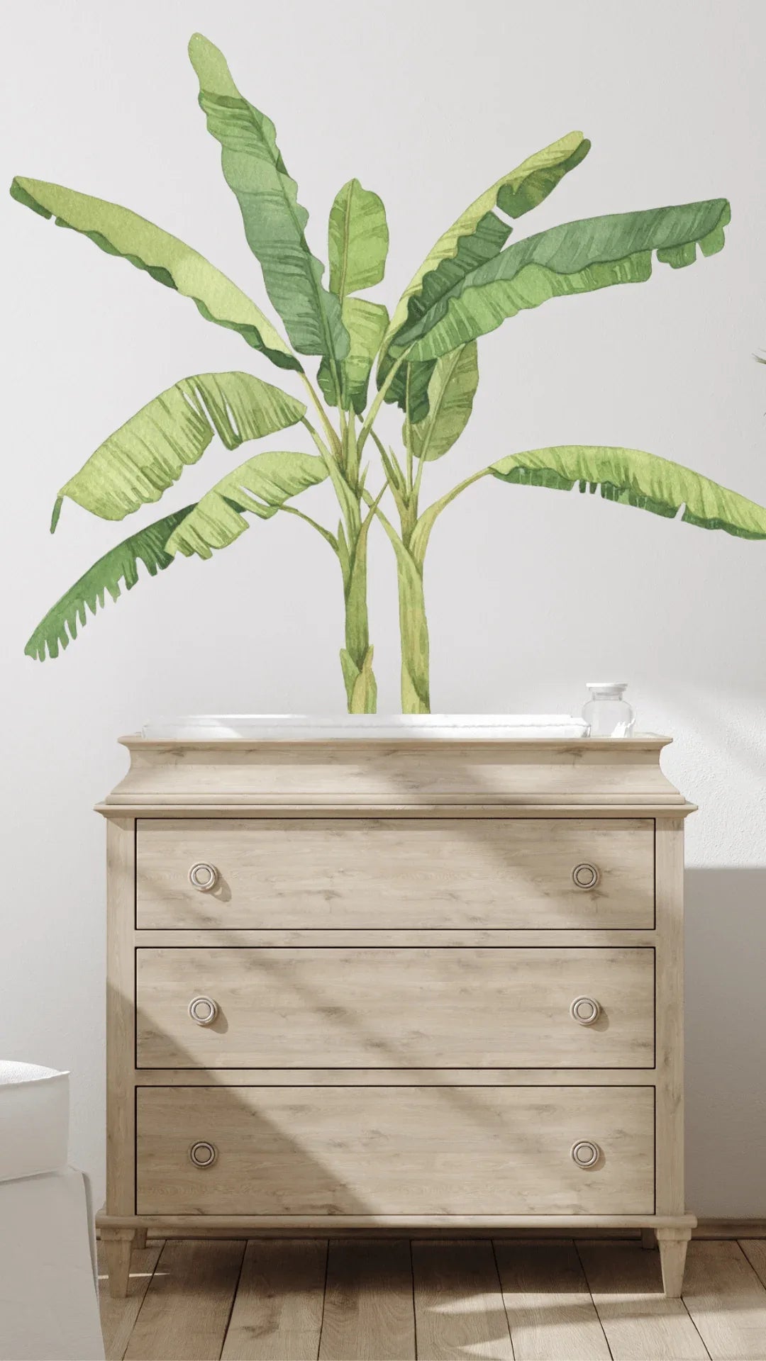 Banana palm tree wall decal above a timber dresser