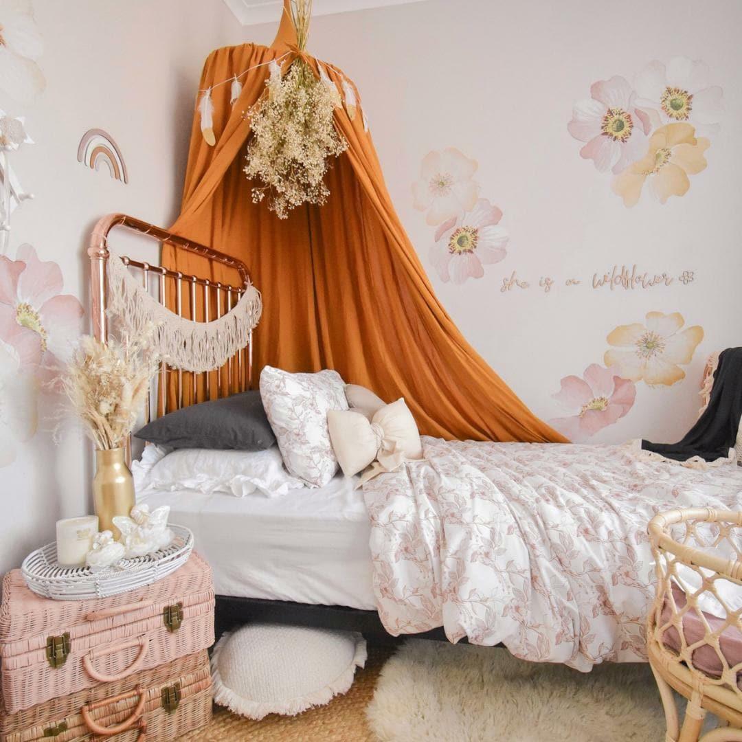 Marigold floral decals in a girls bedroom with a rust canopy