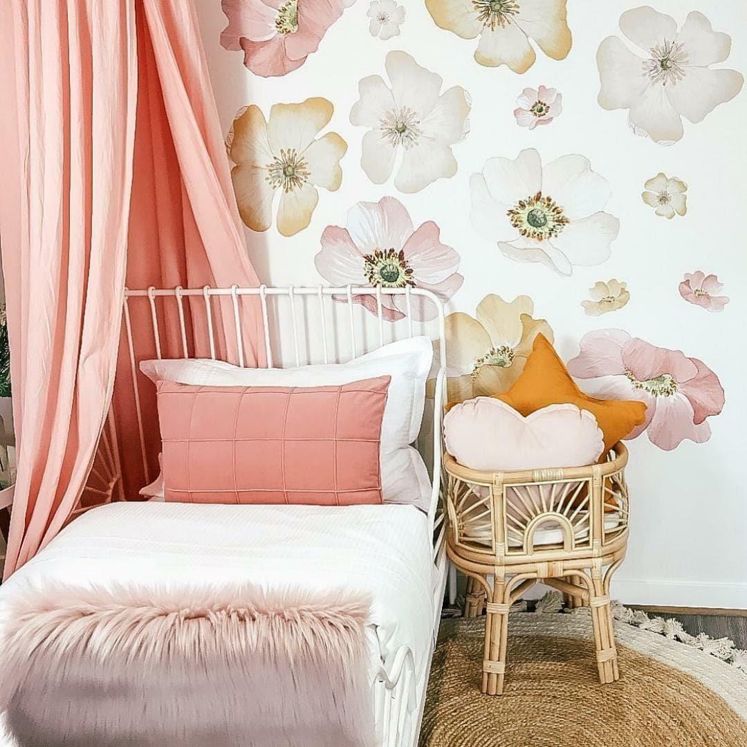 Marigold floral decals in a girls bedroom with a pink canopy and cane stool