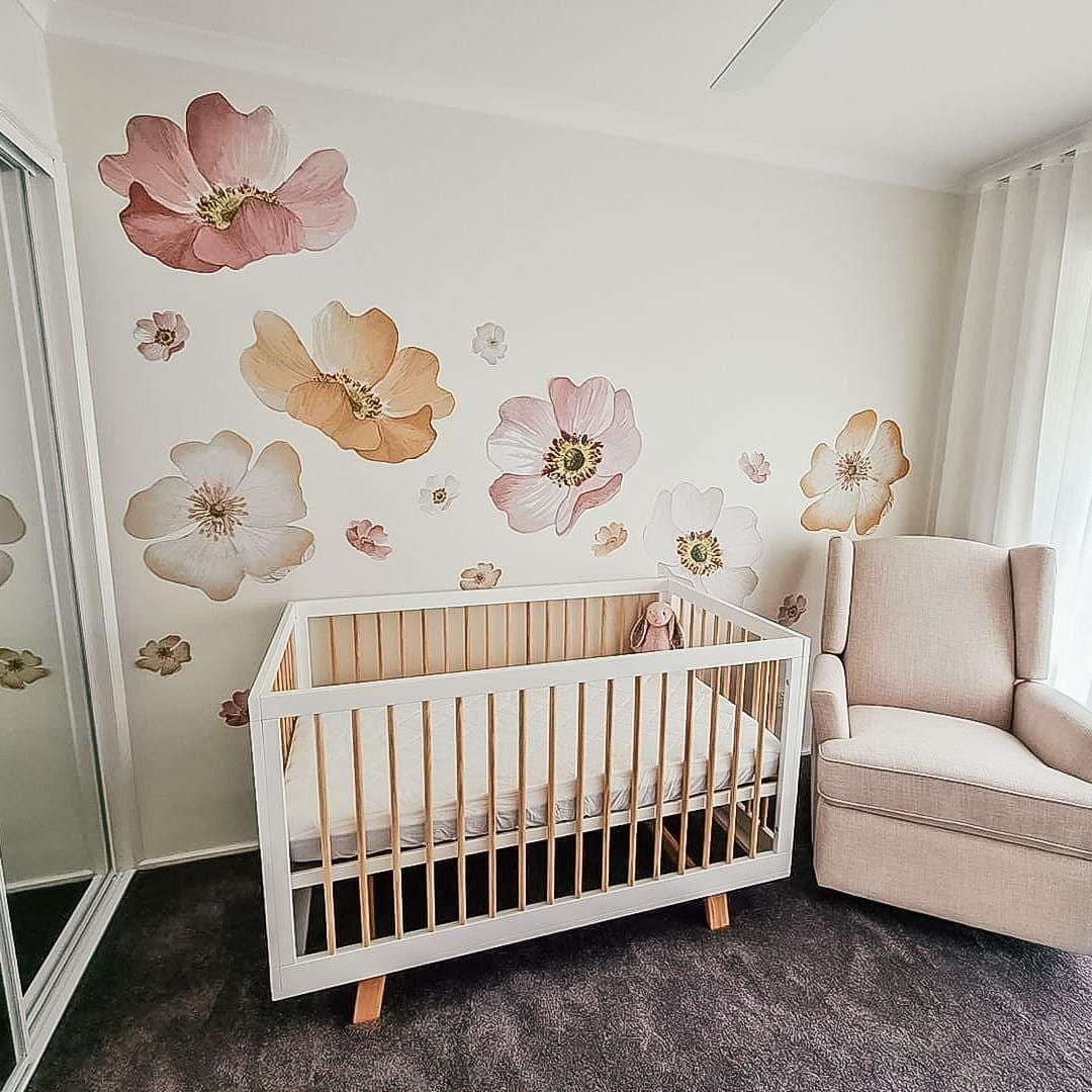 Customer photo of marigold floral decals above a cot in a nursery