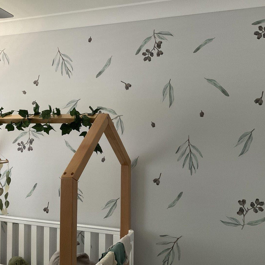 Children's room with crib, decorative wall, and crib mobile.