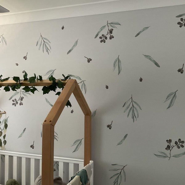 Children's room with crib, decorative wall, and crib mobile.