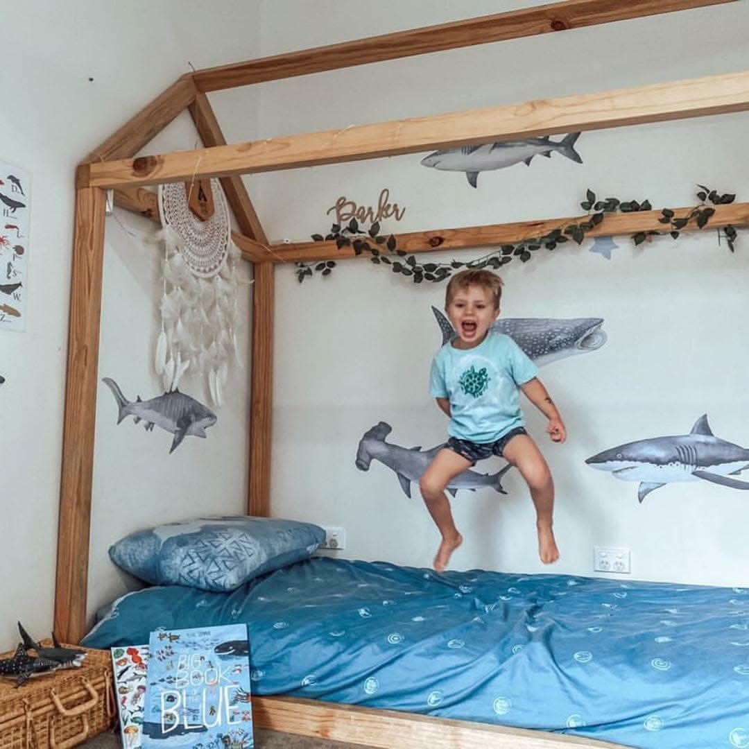 Customer photo of a child with shark decals in a bedroom